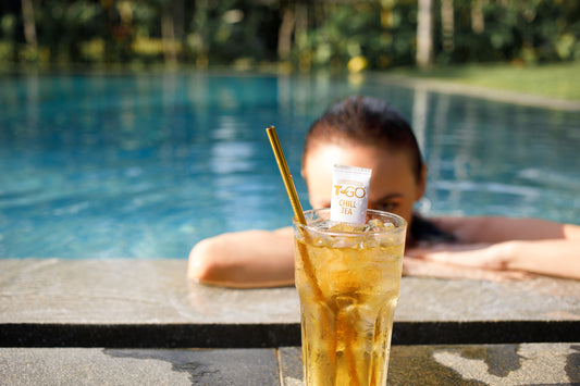 Iced TGO Chill Tea with Straw in a swimming pool background